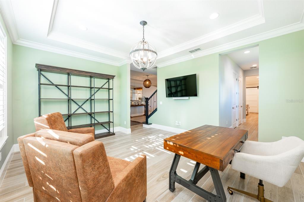 9014 Morgana Court Winter Garden, FL 34787 - Photo 18 of 55 a living room with furniture a window and a flat screen tv