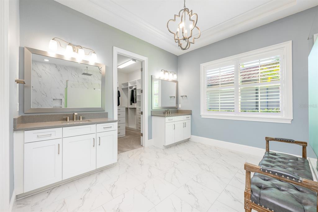 9014 Morgana Court Winter Garden, FL 34787 - Photo 22 of 55 a spacious bathroom with a double vanity sink a large mirror and a bathtub
