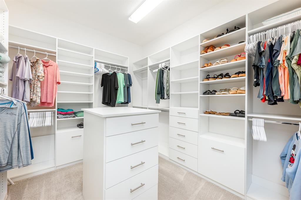 9014 Morgana Court Winter Garden, FL 34787 - Photo 25 of 55 a view of walk in closet with clothes and shoes