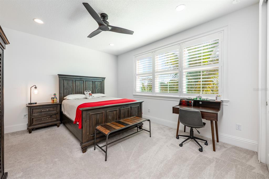 9014 Morgana Court Winter Garden, FL 34787 - Photo 31 of 55 a bedroom with a bed a table and a window