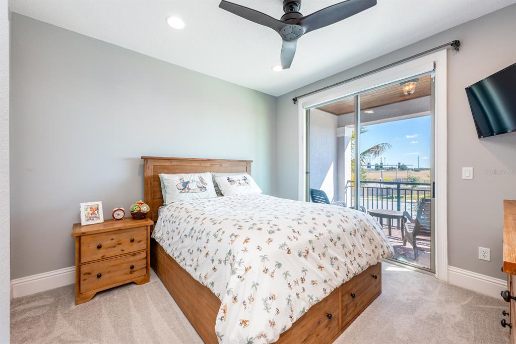 9014 Morgana Court Winter Garden, FL 34787 - Photo 33 of 55 a bedroom with a bed and wooden floor