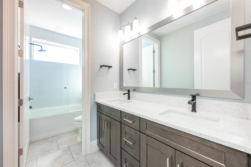 9014 Morgana Court Winter Garden, FL 34787 - Photo 35 of 55 a bathroom with a sink a mirror and a bathtub