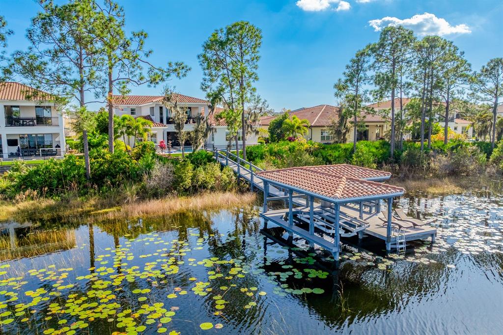 9014 Morgana Court Winter Garden, FL 34787 - Photo 47 of 55 a view of a lake with a table and chairs under an umbrella