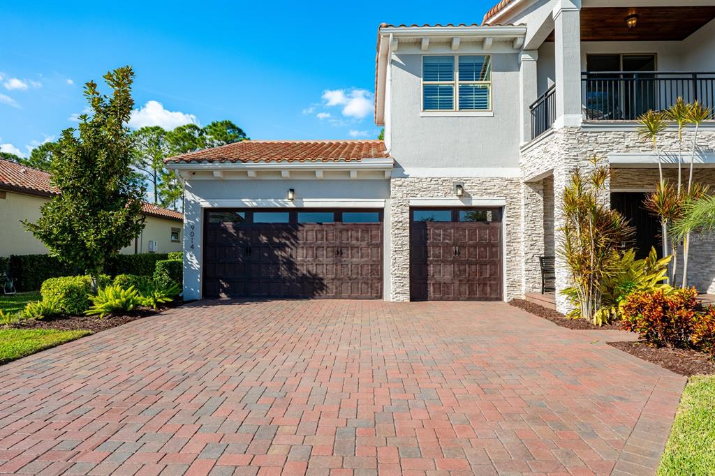 9014 Morgana Court Winter Garden, FL 34787 - Photo 54 of 55 a front view of a house with a yard and a garage