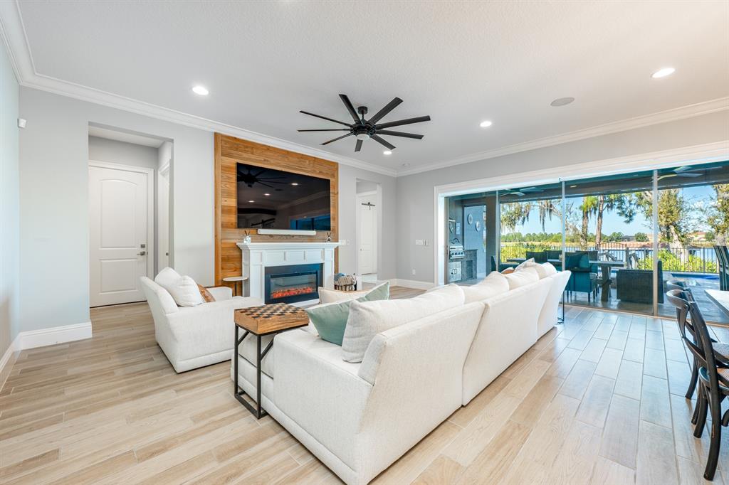 9014 Morgana Court Winter Garden, FL 34787 - Photo 9 of 55 a living room with fireplace furniture and a flat screen tv