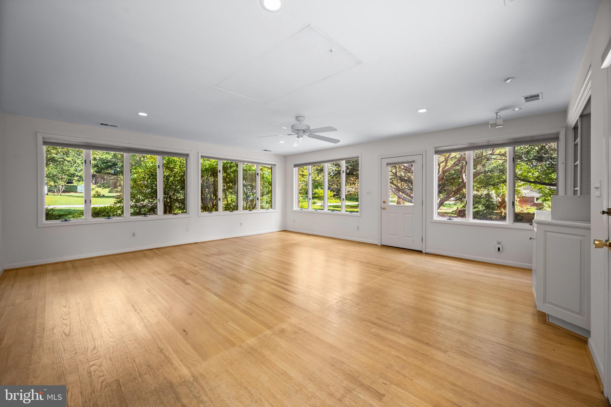 5002 Durham Road East Columbia, MD 21044 - Photo 24 of 62 an empty room with large windows and wooden floor