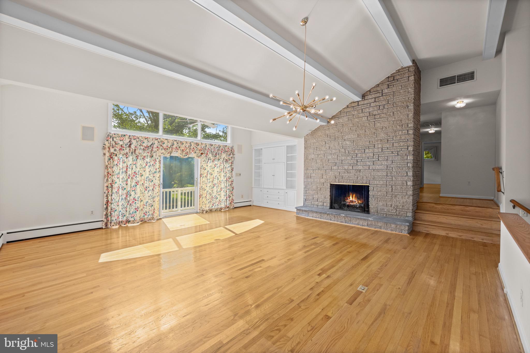 5002 Durham Road East Columbia, MD 21044 - Photo 34 of 62 a view of an empty room with wooden floor and a fireplace