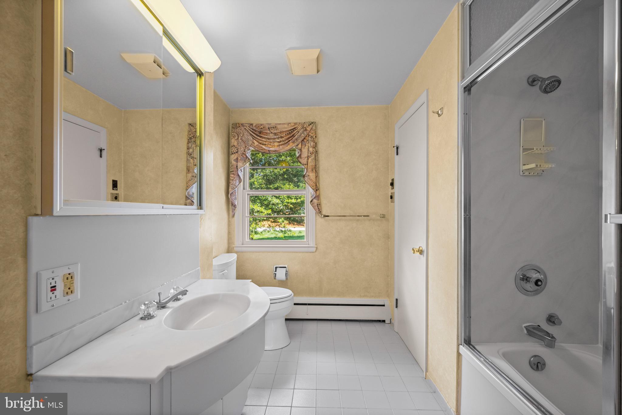 5002 Durham Road East Columbia, MD 21044 - Photo 38 of 62 a bathroom with a tub sink toilet and a window