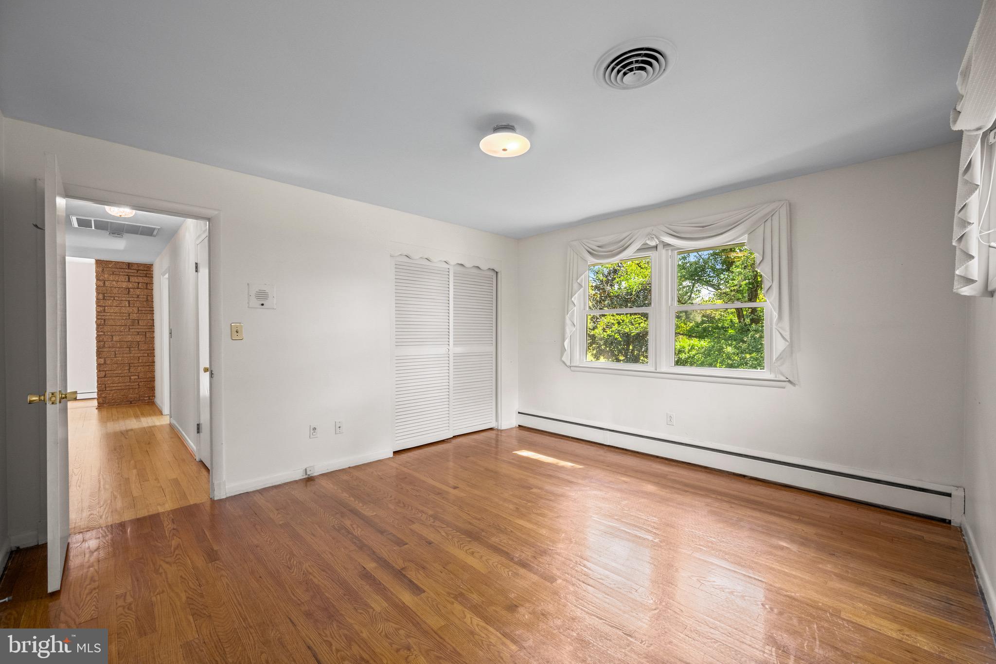 5002 Durham Road East Columbia, MD 21044 - Photo 45 of 62 an empty room with wooden floor and windows
