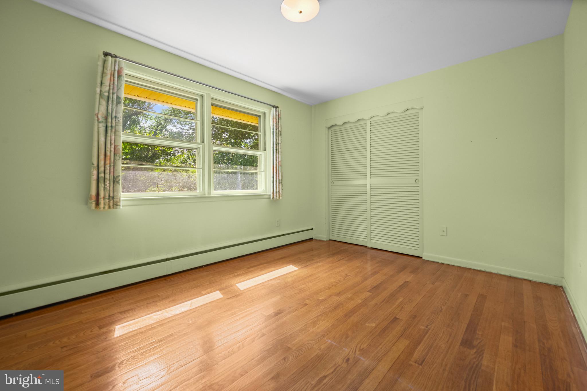 5002 Durham Road East Columbia, MD 21044 - Photo 46 of 62 an empty room with wooden floor and windows
