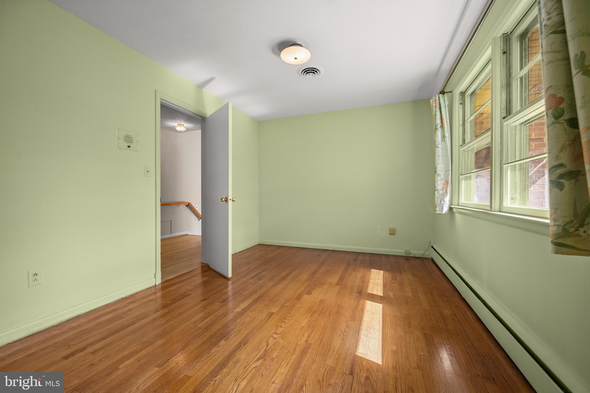 5002 Durham Road East Columbia, MD 21044 - Photo 47 of 62 an empty room with wooden floor and windows