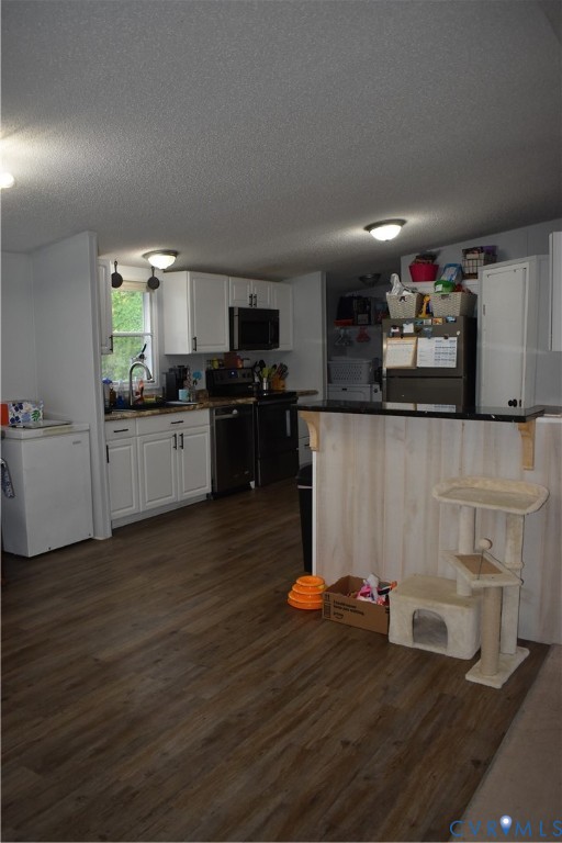 26049 Guy Place Road Courtland, VA 23837 - Photo 10 of 24 Kitchen featuring wood-finish flooring, white cabi