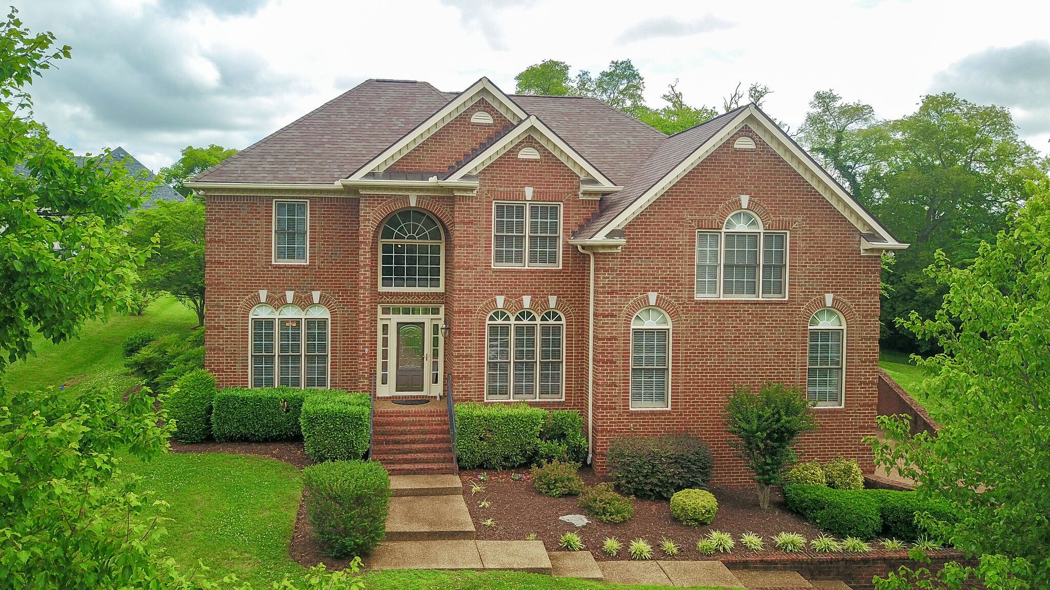 a front view of a house with a yard