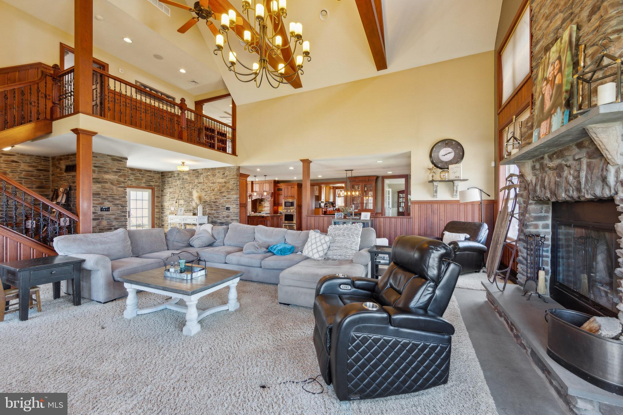 86 Sunset Road Royersford, PA 19468 - Photo 13 of 75 a living room with furniture a fireplace and a chandelier