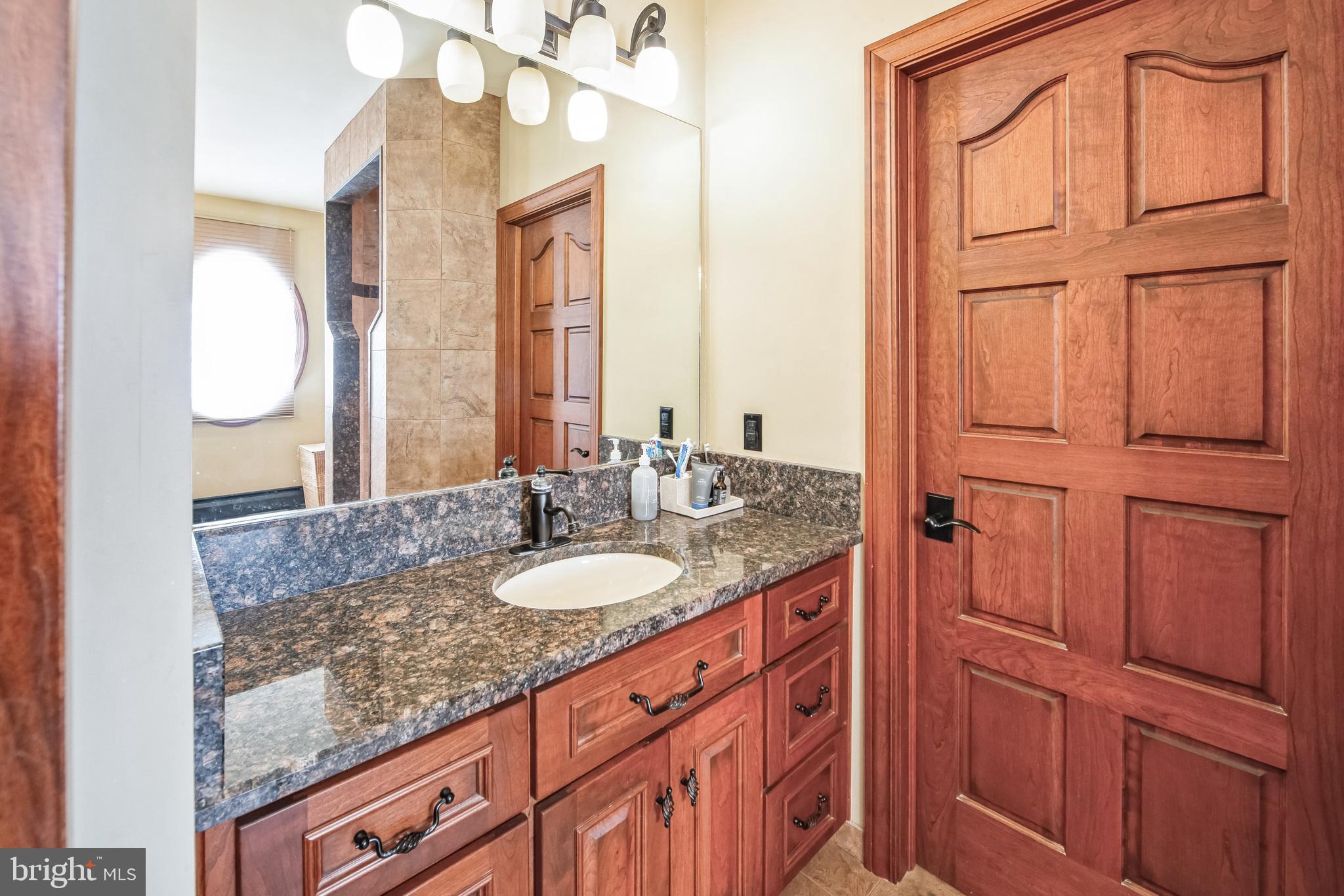 86 Sunset Road Royersford, PA 19468 - Photo 37 of 75 a bathroom with a granite countertop sink and a mirror