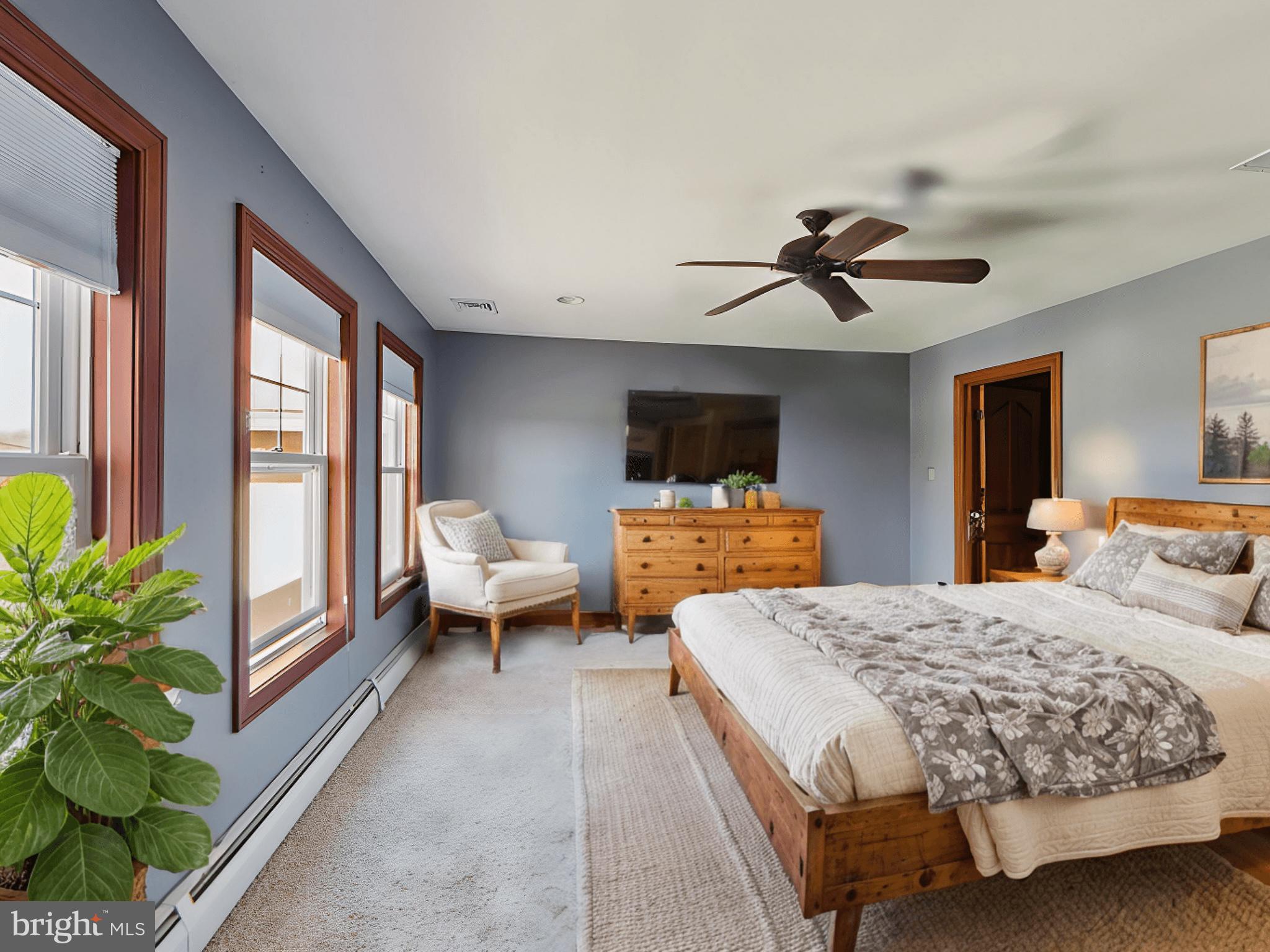 86 Sunset Road Royersford, PA 19468 - Photo 47 of 75 a spacious bedroom with a bed and a flat screen tv