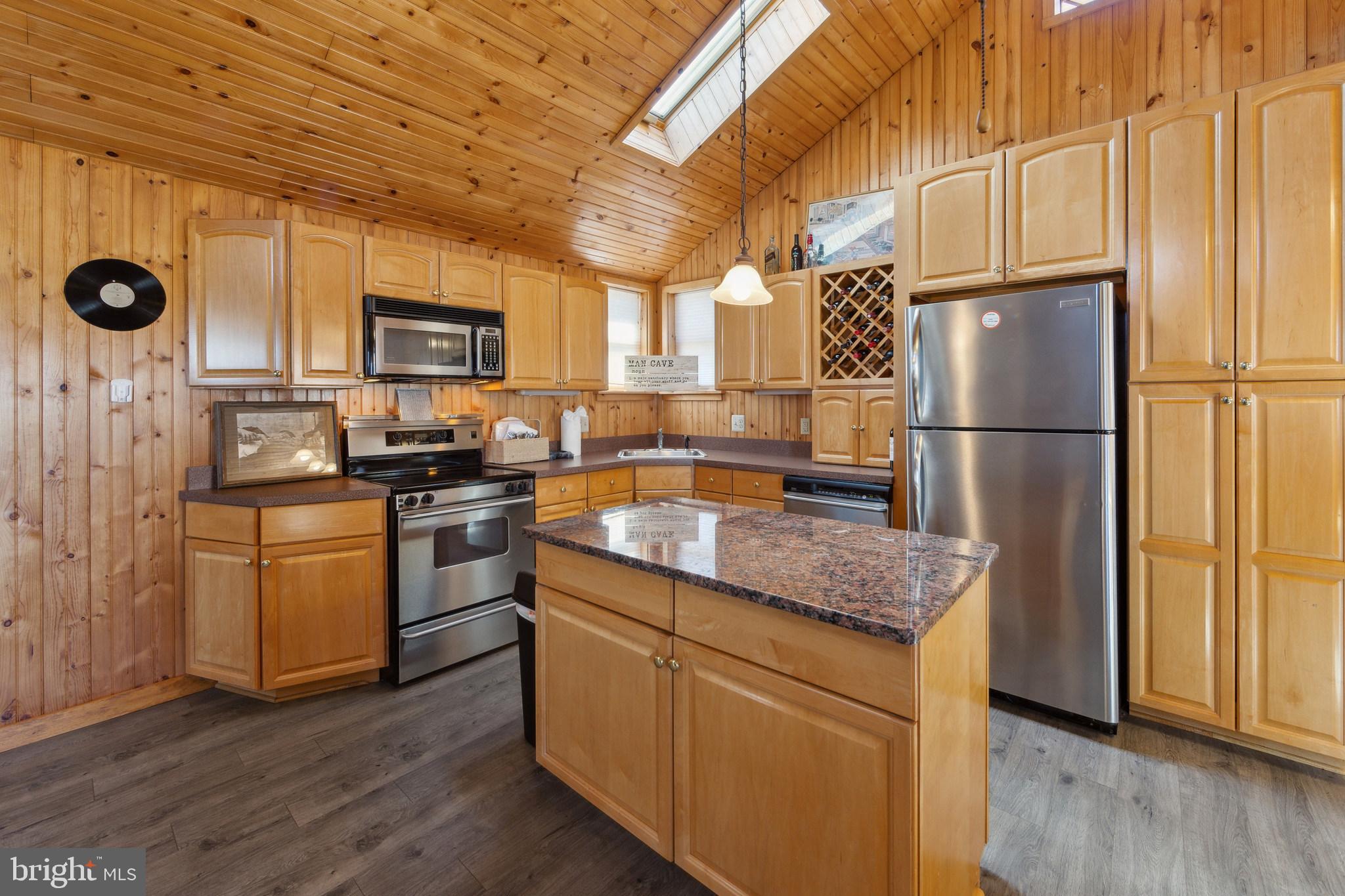 86 Sunset Road Royersford, PA 19468 - Photo 56 of 75 a kitchen with kitchen island granite countertop a refrigerator stove top oven and sink