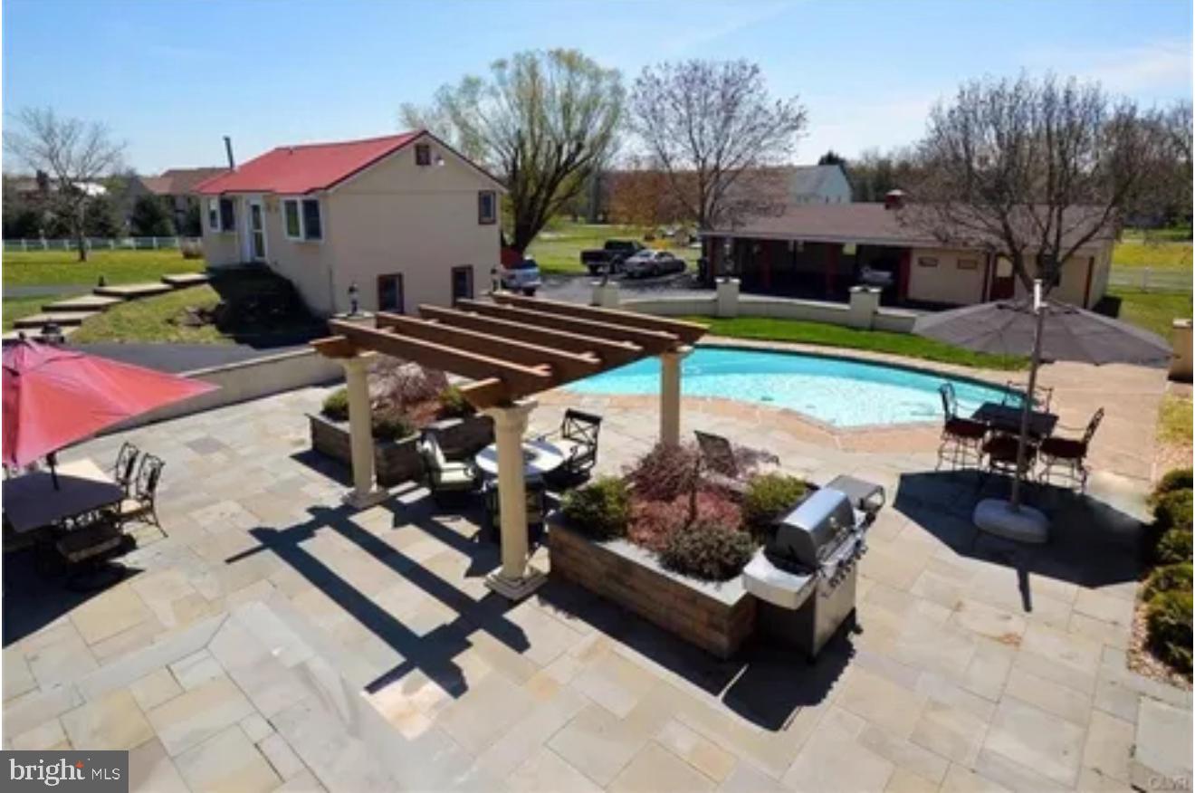 86 Sunset Road Royersford, PA 19468 - Photo 8 of 75 a view of a swimming pool with chairs and a yard