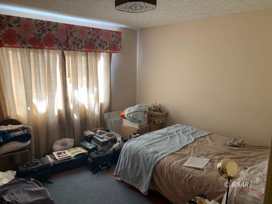 1302 South Mahan Street Ridgecrest, CA 93555 - Photo 9 of 17 a bedroom with a bed and a window
