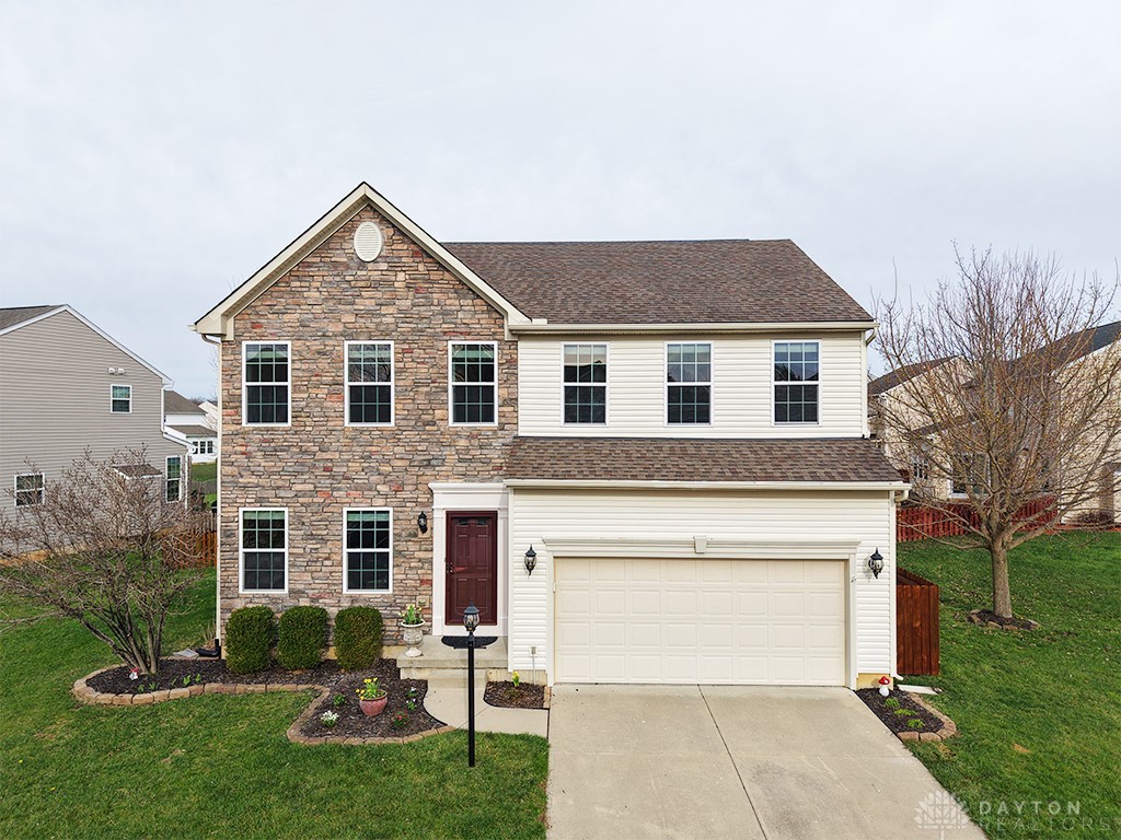 1978 Spring Ridge Drive Xenia, OH 45385 - Photo 1 of 44 This classic two-story residence features a stone and siding facade with an attached garage and a well-maintained lawn.