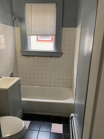 a bathroom with a bathtub and a sink