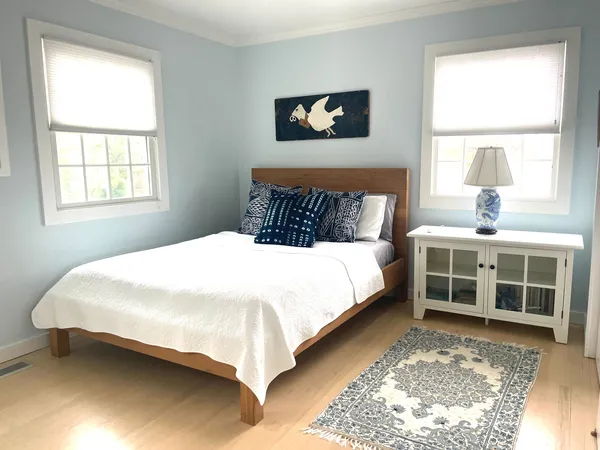 a view of a bedroom with bed and window