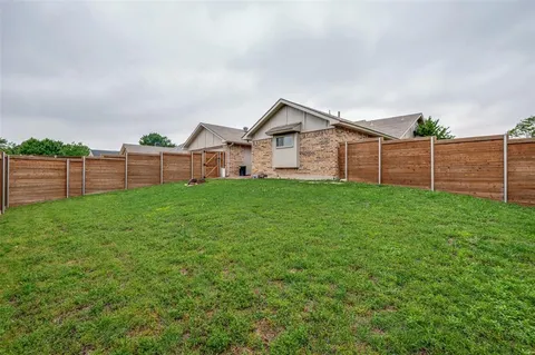a view of a house with a yard and sitting area