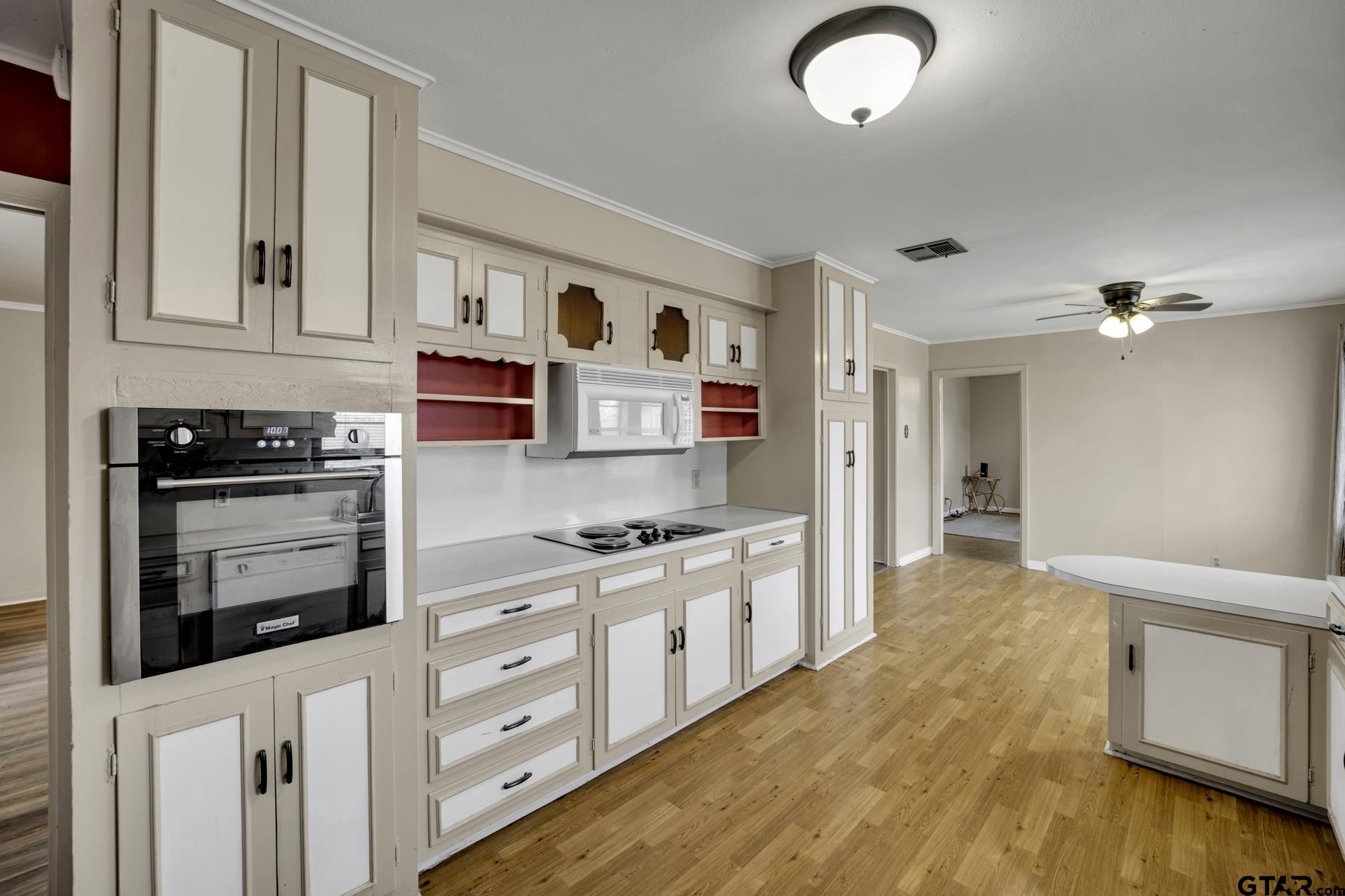 3204 West Tulsa Street Tyler, TX 75702 - Photo 12 of 24 a kitchen with stainless steel appliances granite countertop a stove and a refrigerator