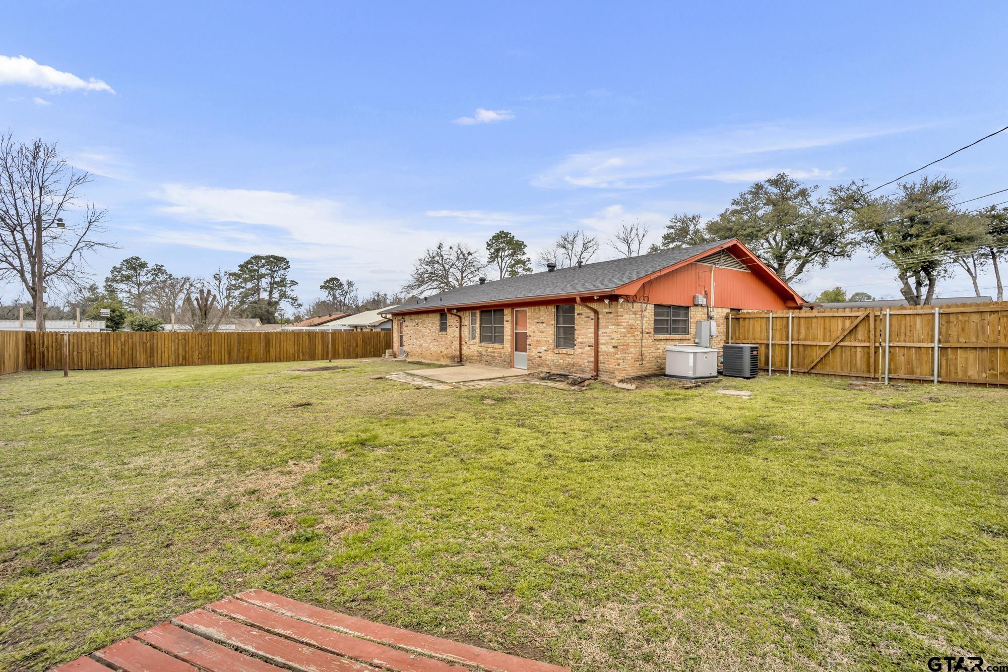 3204 West Tulsa Street Tyler, TX 75702 - Photo 22 of 24 a view of a house with a yard