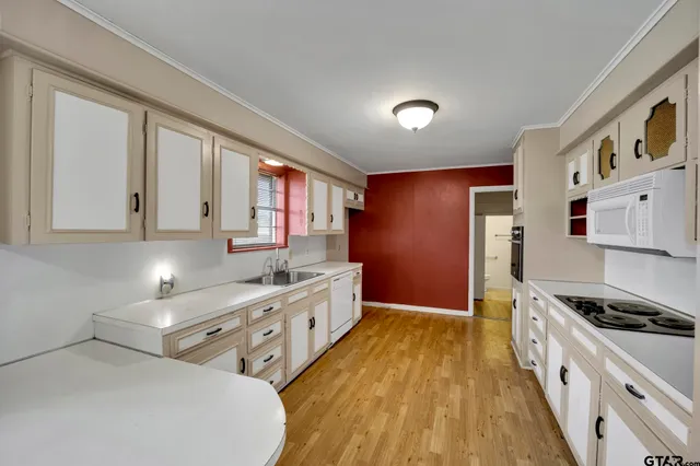 a kitchen with stainless steel appliances a stove a sink and a refrigerator