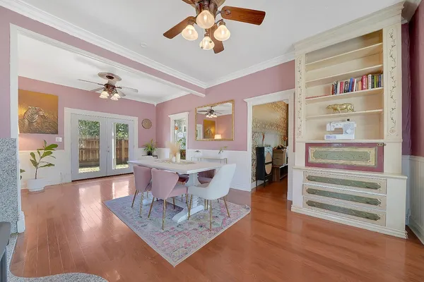 a view of a livingroom with furniture wooden floor and a ceiling fan