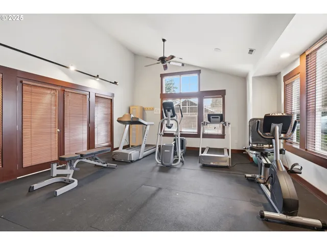 a room with gym equipment and a large window