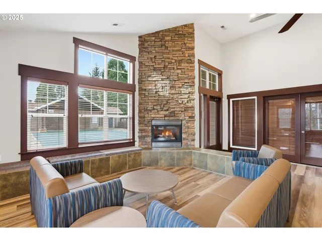 a living room with furniture and large windows