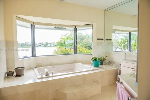 a bath tub sitting in a bathroom next to a window