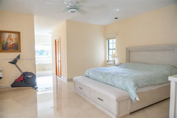 a spacious bedroom with a bed and a dresser