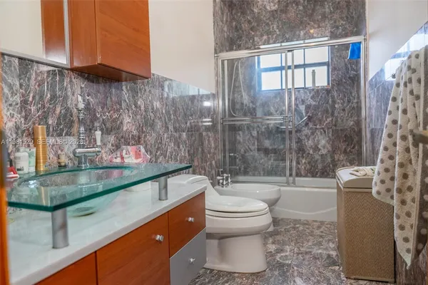 a bathroom with a sink toilet and shower