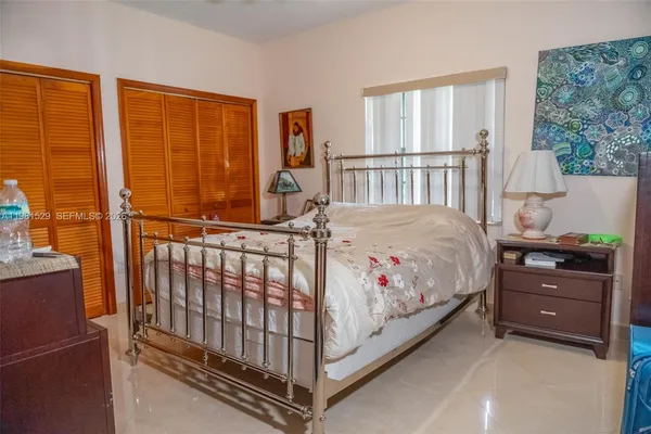 a bedroom with a bed and a window