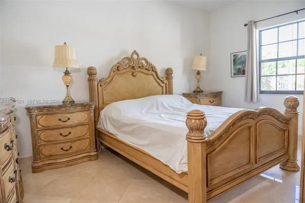 a bed sitting in a bedroom next to a window