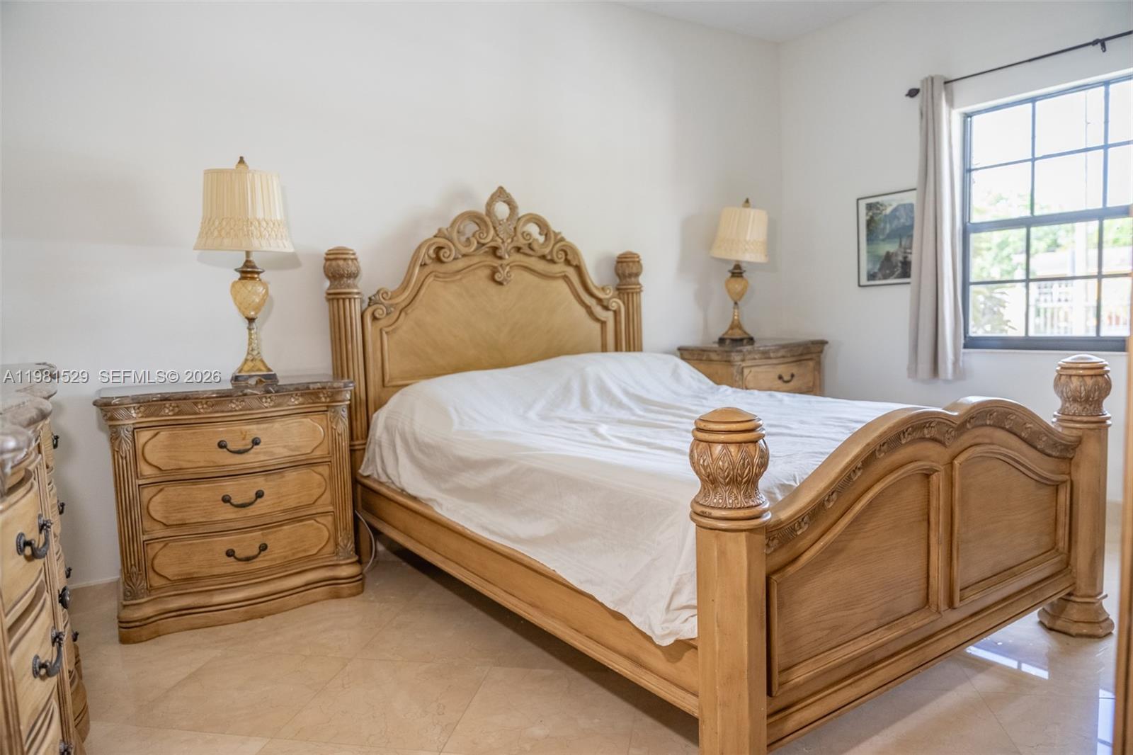 4655 Southwest 89th Avenue Miami, FL 33165 - Photo 20 of 38 a bed sitting in a bedroom next to a window