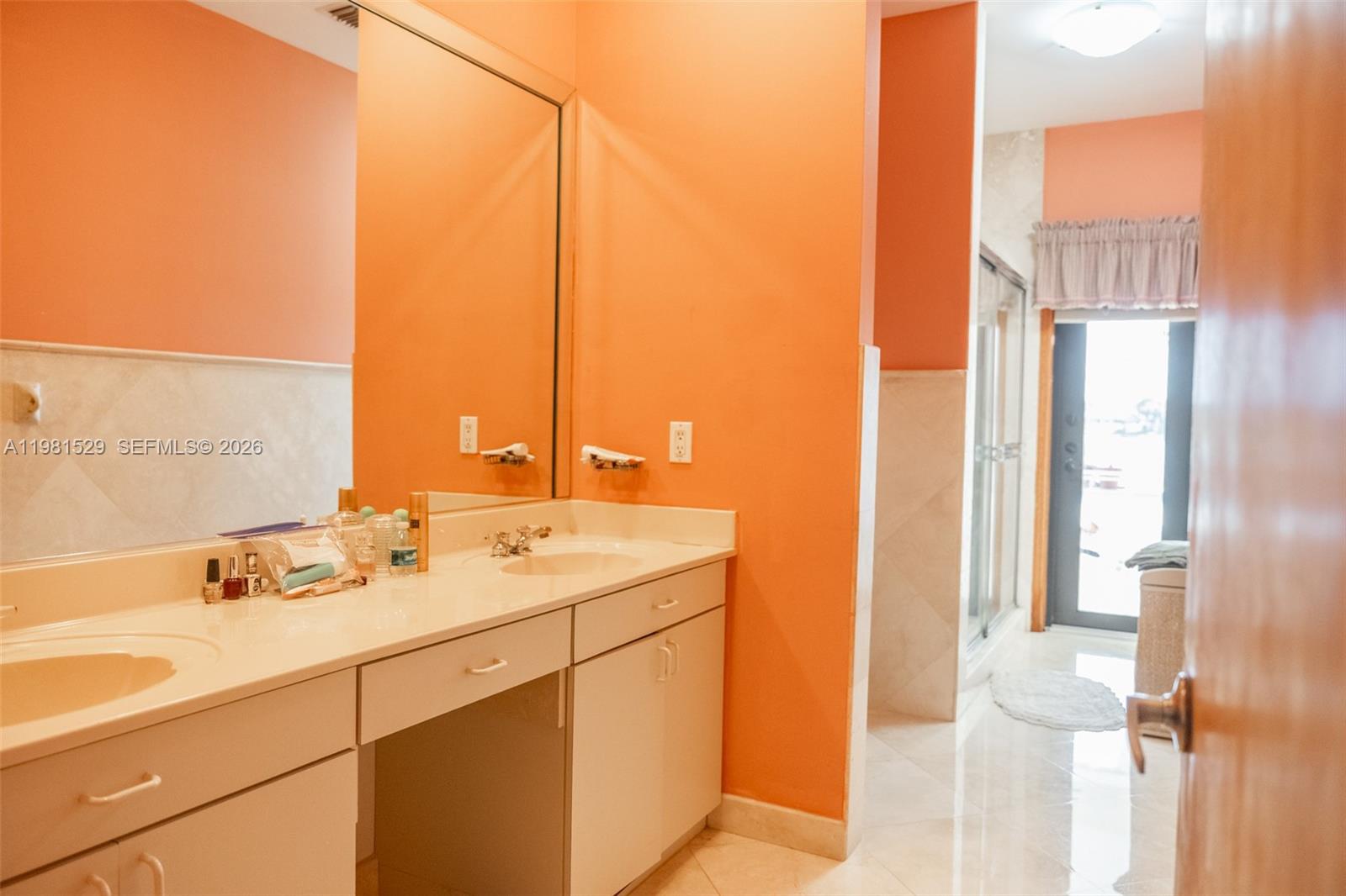 4655 Southwest 89th Avenue Miami, FL 33165 - Photo 21 of 38 a bathroom with a double vanity sink and mirror