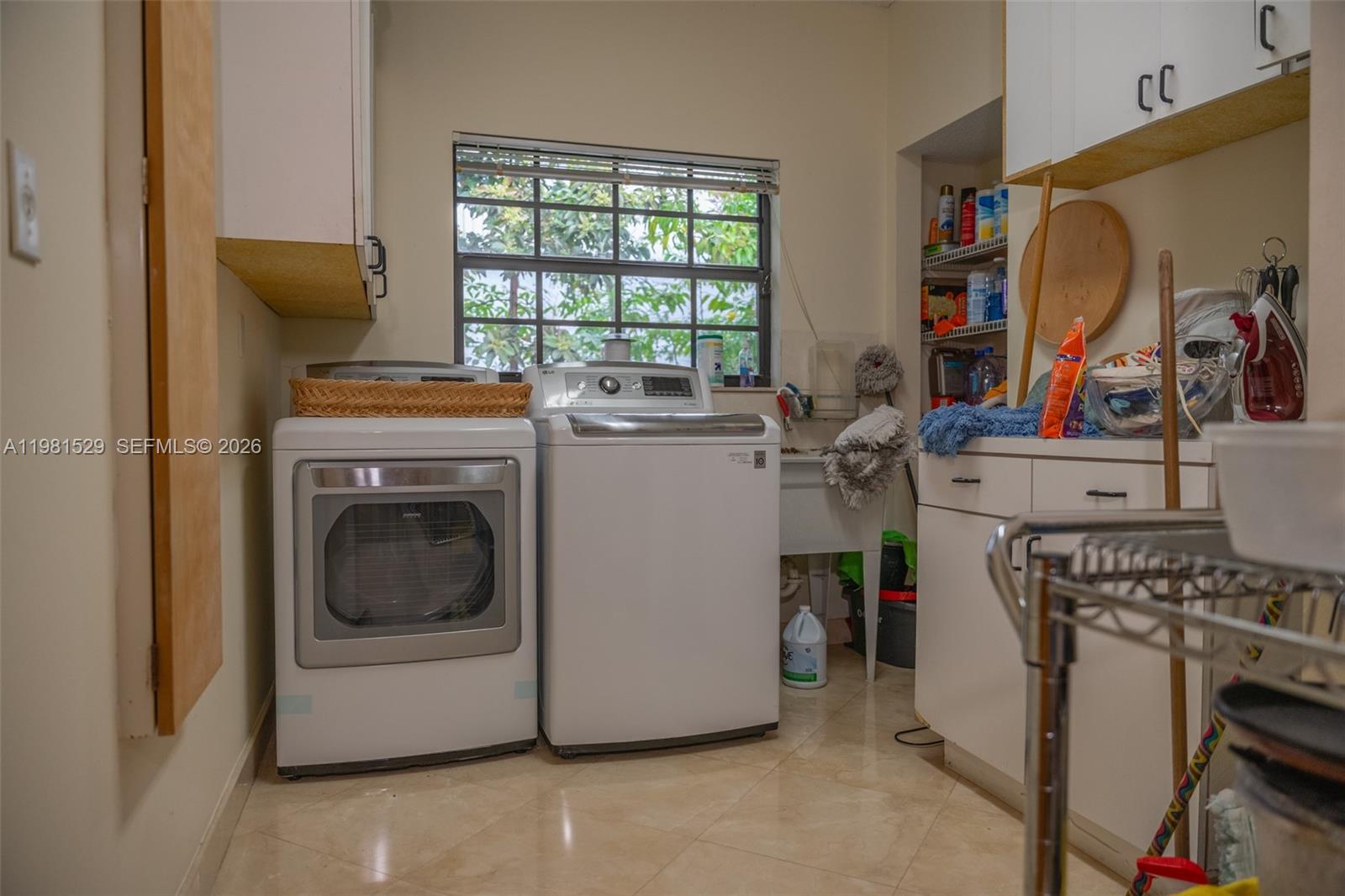 4655 Southwest 89th Avenue Miami, FL 33165 - Photo 24 of 38 a utility room with dryer washer and a window