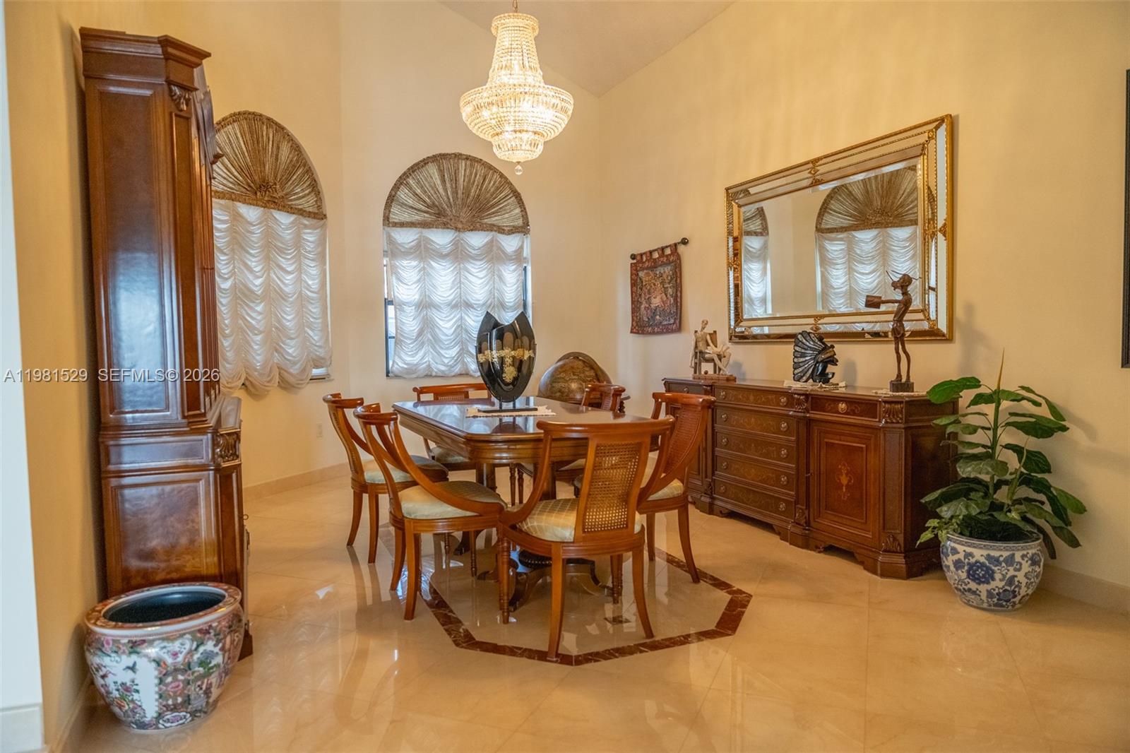 4655 Southwest 89th Avenue Miami, FL 33165 - Photo 6 of 38 a dining room with furniture a chandelier and wooden floor
