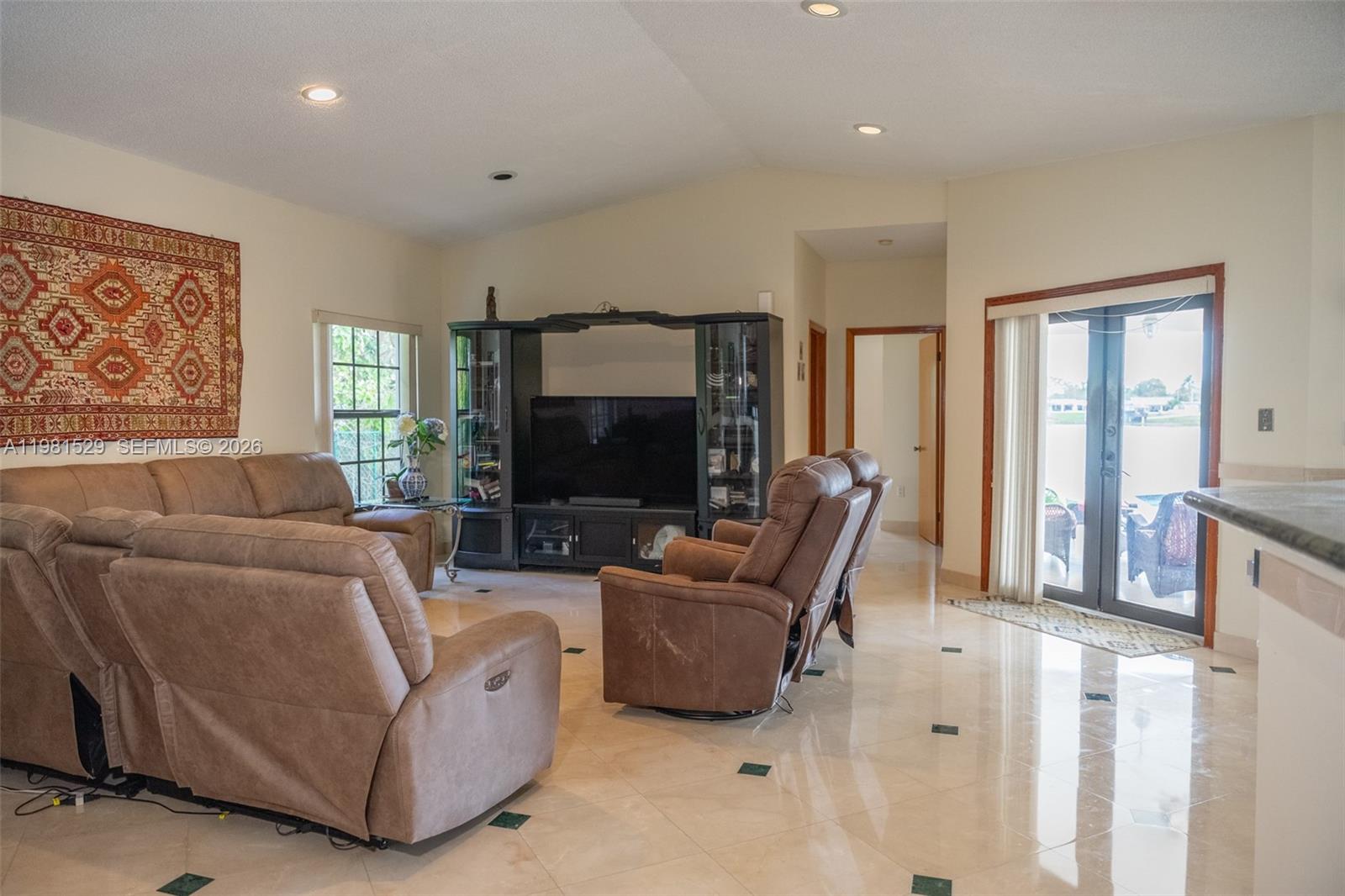 4655 Southwest 89th Avenue Miami, FL 33165 - Photo 8 of 38 a living room with furniture and a flat screen tv