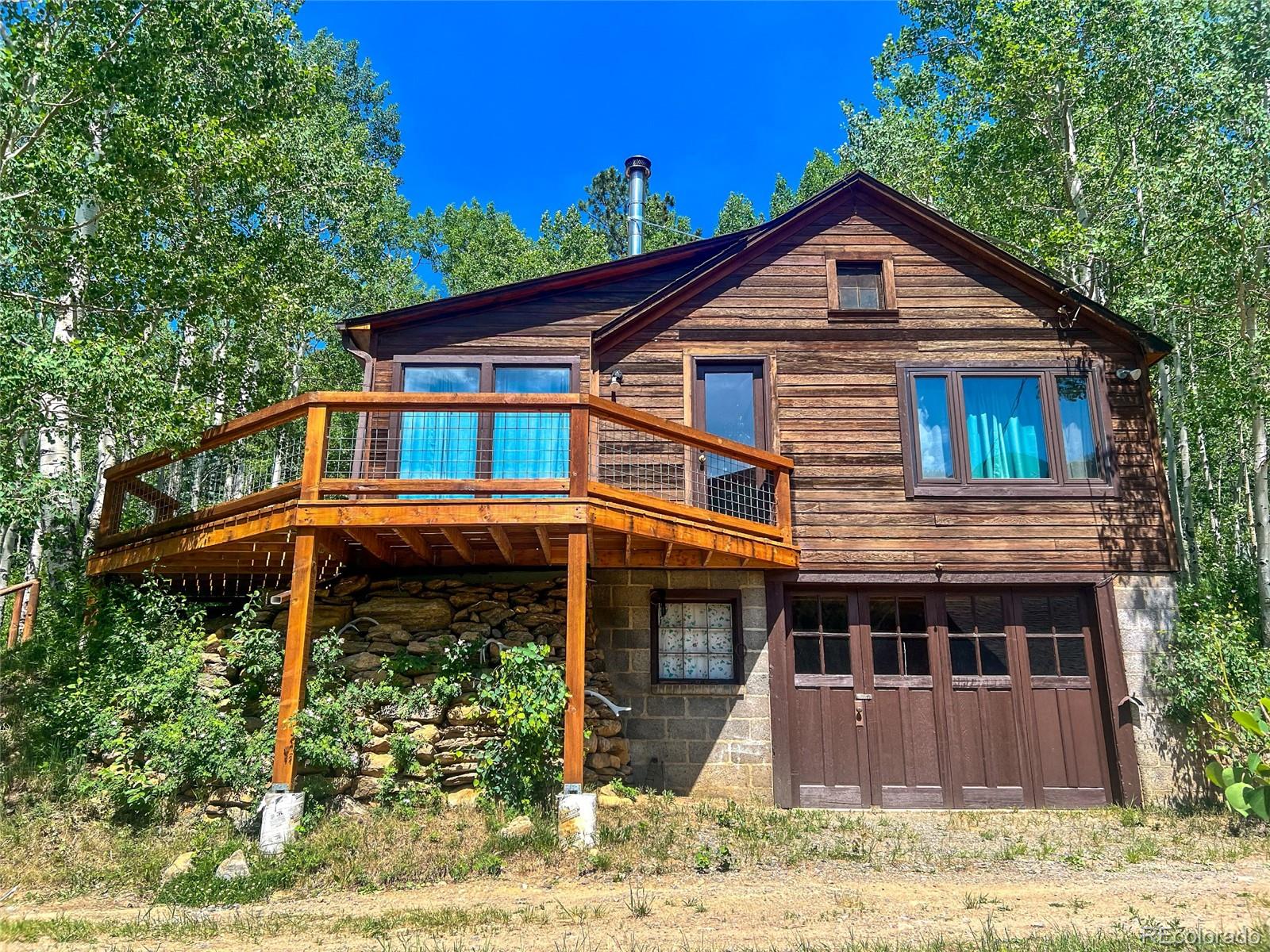 950 Corral Creek Road Evergreen, CO 80439 - Photo 18 of 50 a front view of a house with garden