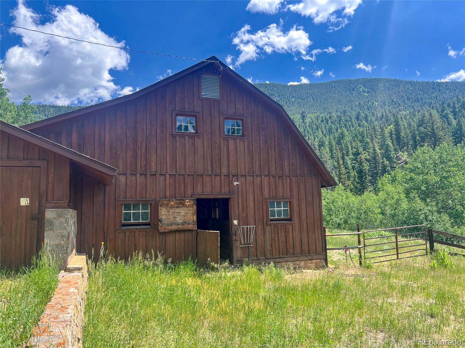 950 Corral Creek Road Evergreen, CO 80439 - Photo 19 of 50 a front view of a house with garden