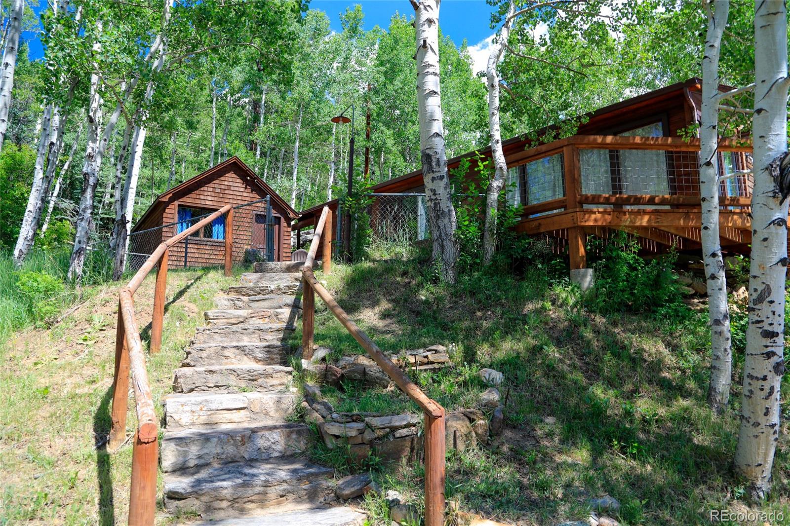 950 Corral Creek Road Evergreen, CO 80439 - Photo 20 of 50 a front view of a house with a yard