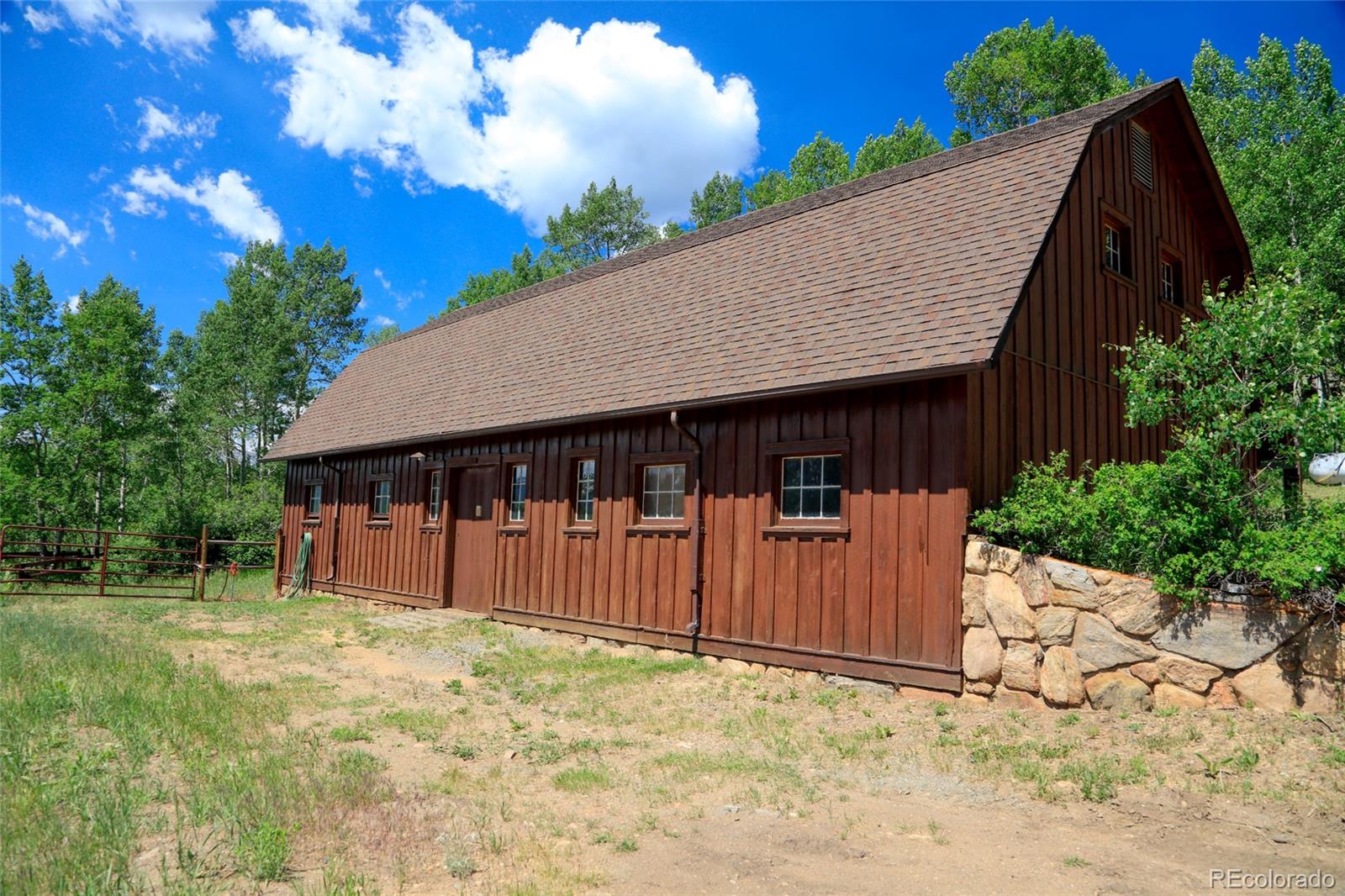 950 Corral Creek Road Evergreen, CO 80439 - Photo 23 of 50 a backyard of a house with lots of green space