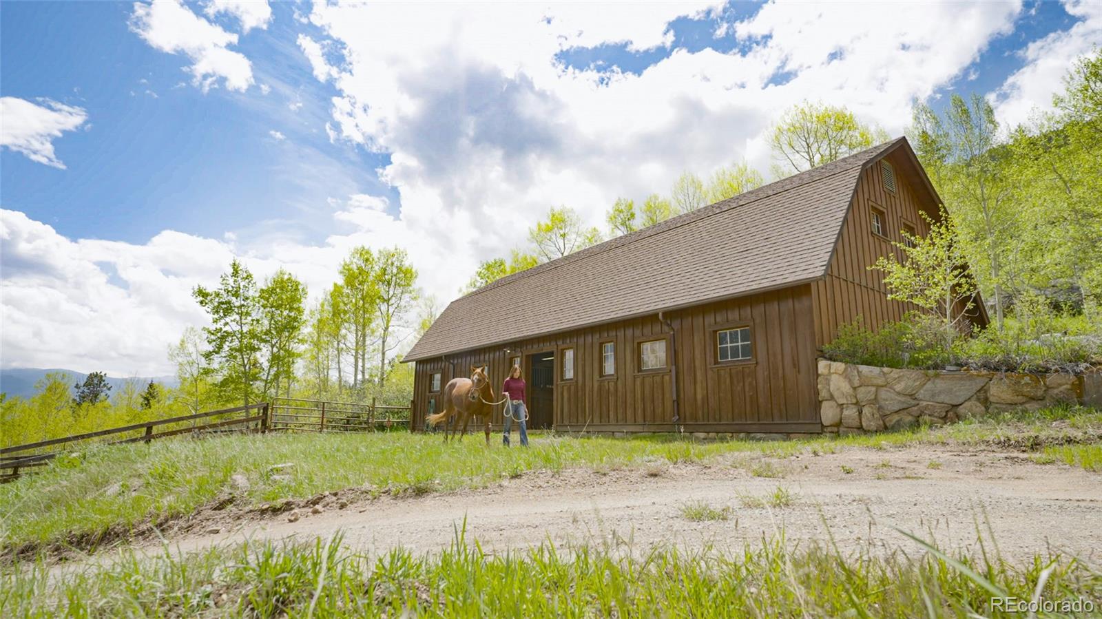 950 Corral Creek Road Evergreen, CO 80439 - Photo 38 of 50 a front view of a house with garden
