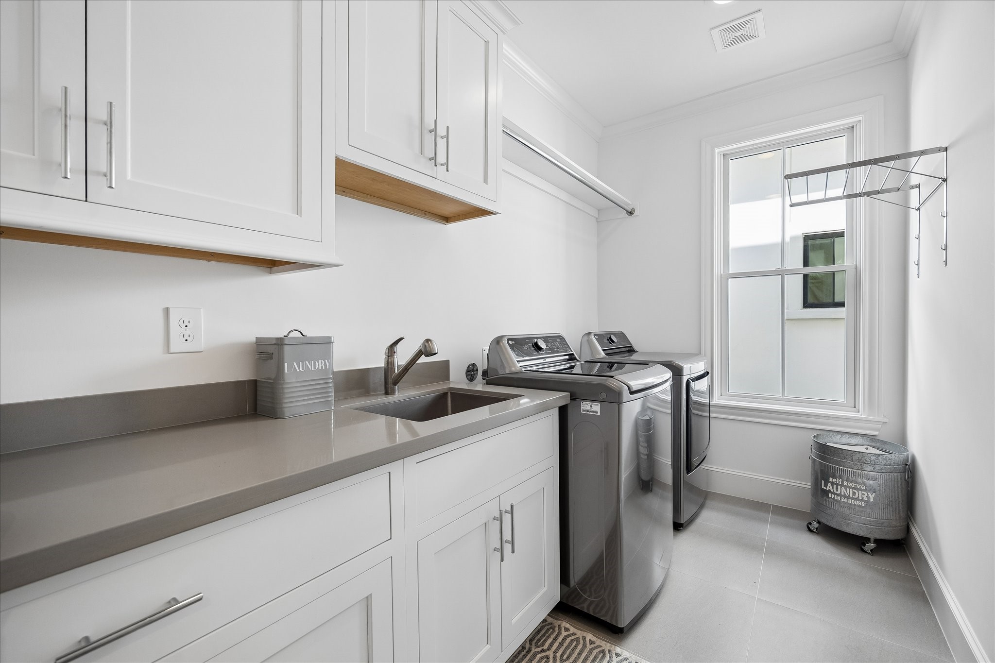 3020 Lake Street Houston, TX 77098 - Photo 36 of 43 The laundry room, located on the second floor, includes a sink and storage.