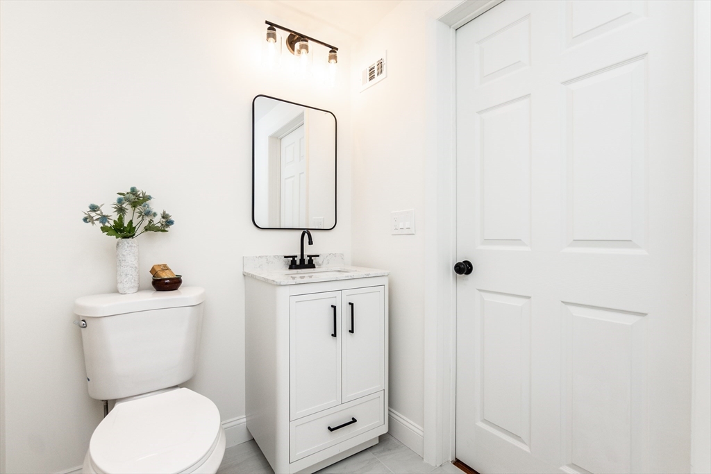 72 Outlook Road Wakefield, MA 01880 - Photo 20 of 42 a bathroom with a toilet sink and mirror